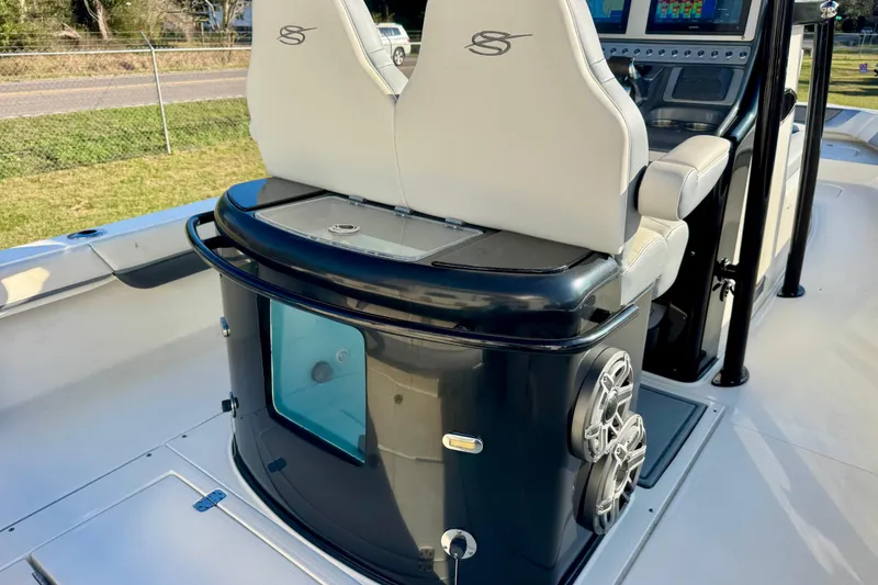 Slide: The Image of 2021 ShearWater 27 Carolina boat interior with dual seats and control panel. - 13