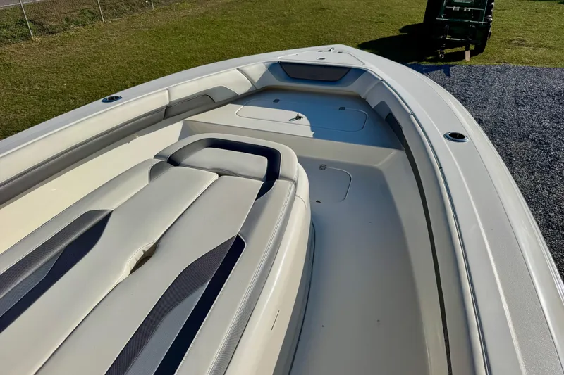 Slide: The Image of 2021 ShearWater 27 Carolina boat interior with cushioned seating and storage compartments. - 6