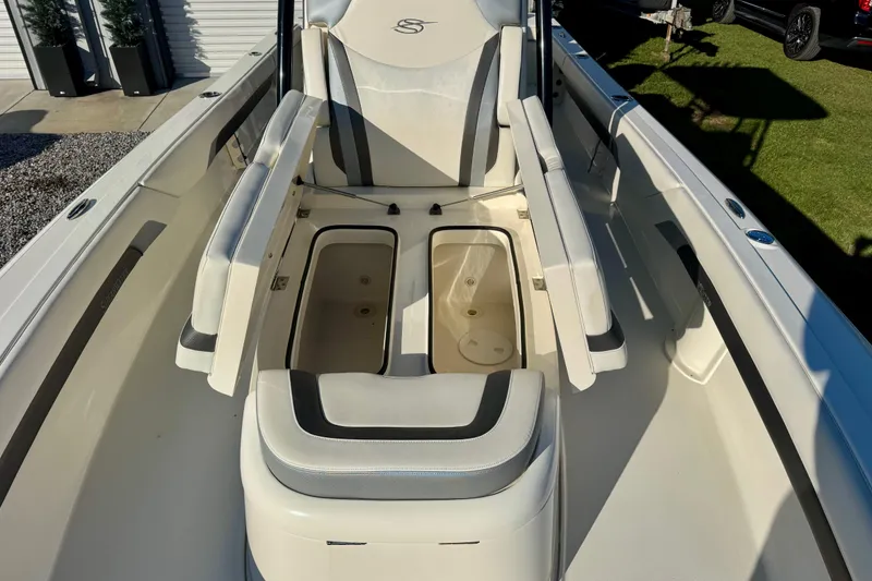 Slide: The Image of 2021 ShearWater 27 Carolina boat interior with seating and storage compartments. - 8