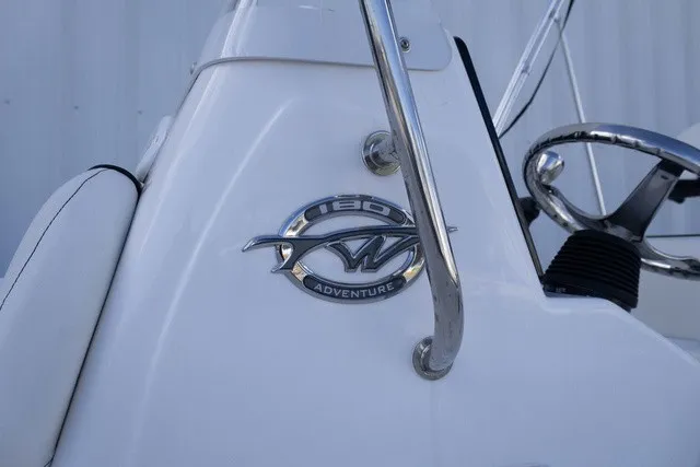 Slide: The Image of Close-up of the logo on a white boat, model Tidewater 180 CC Adventure. - 13