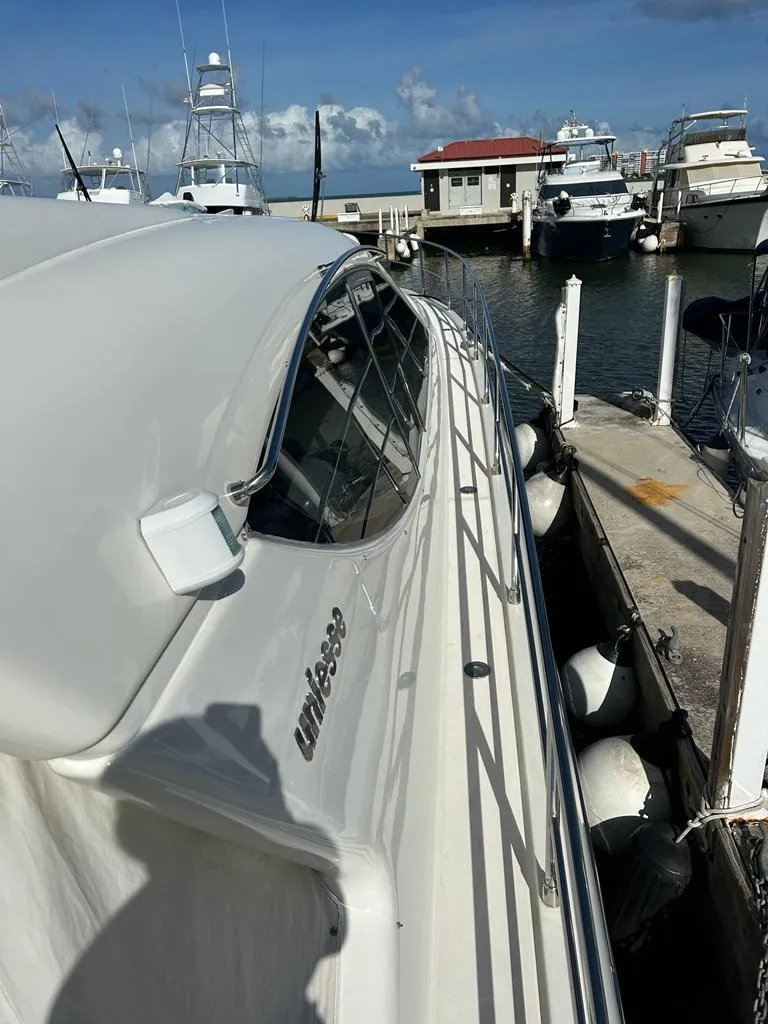 Slide: The Image of 2007 Uniesse 54 Sport yacht docked at a marina on a sunny day. - 10