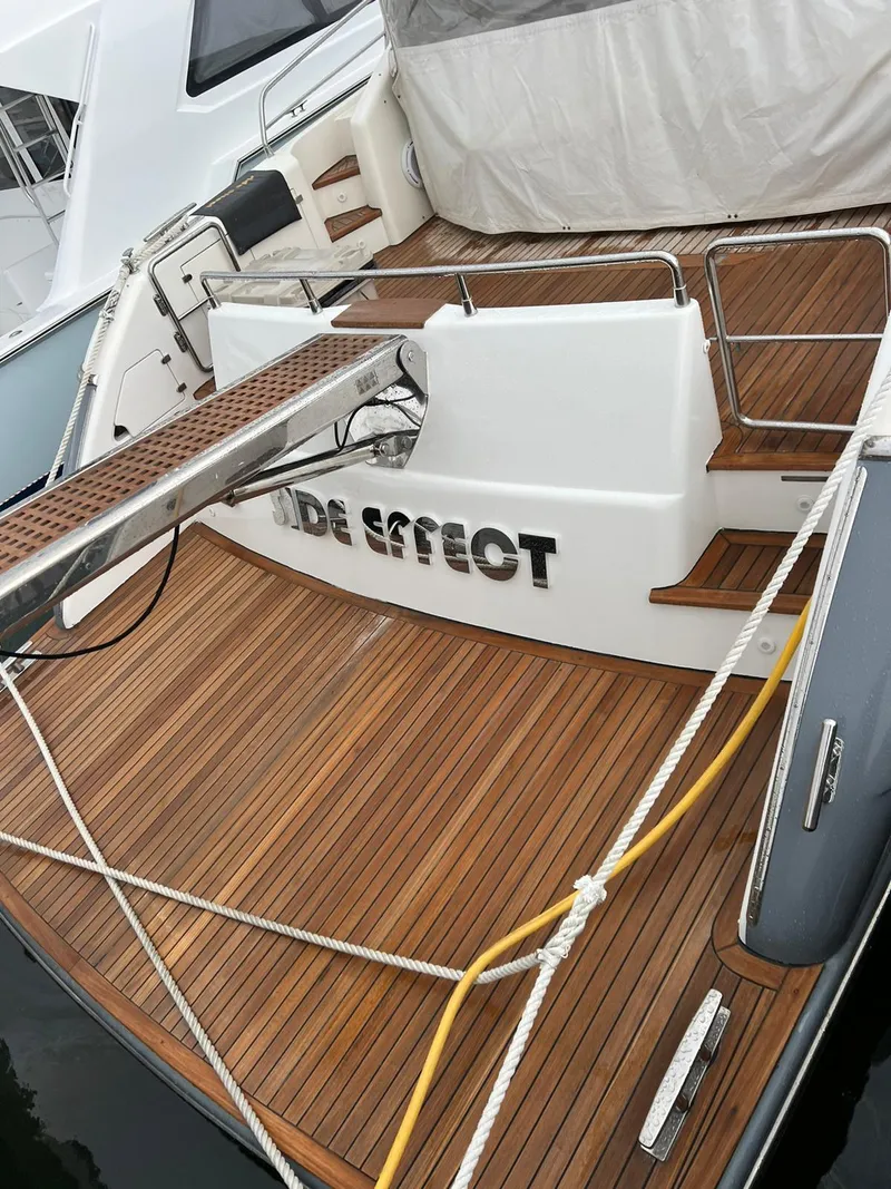 Slide: The Image of 2007 Uniesse 54 Sport yacht with teak deck and Side Effect nameplate. - 12