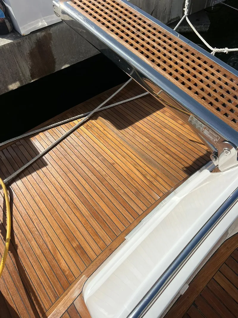 Slide: The Image of Teak deck of a 2007 Uniesse 54 Sport yacht at the dock. - 13