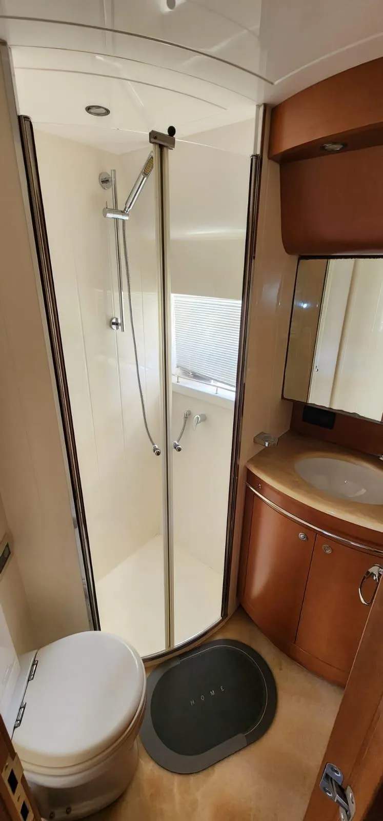 Slide: The Image of 2007 Uniesse 54 Sport yacht bathroom with shower, sink, and toilet. - 16