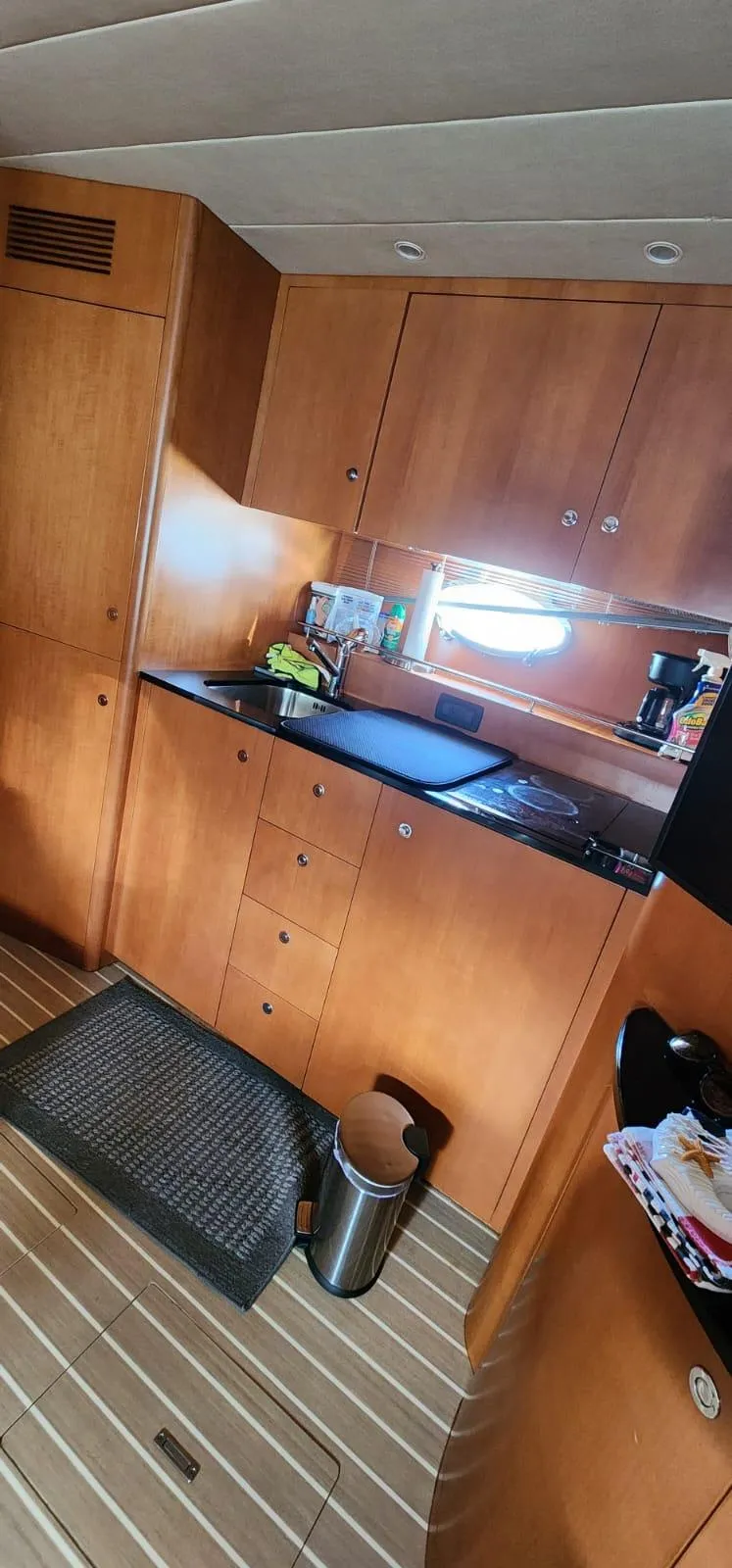 Slide: The Image of 2007 Uniesse 54 Sport yacht kitchen with wooden cabinets and modern appliances. - 20