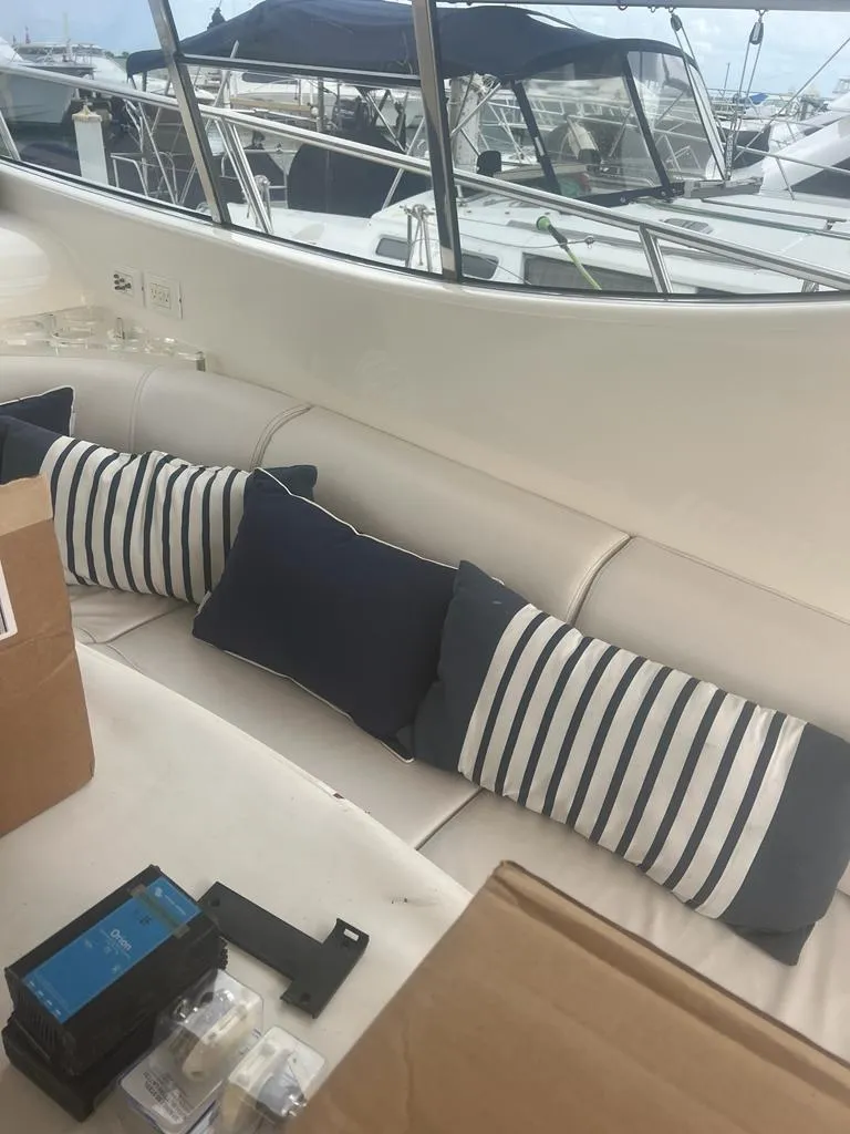 Slide: The Image of 2007 Uniesse 54 Sport yacht interior with striped cushions and marina view. - 3