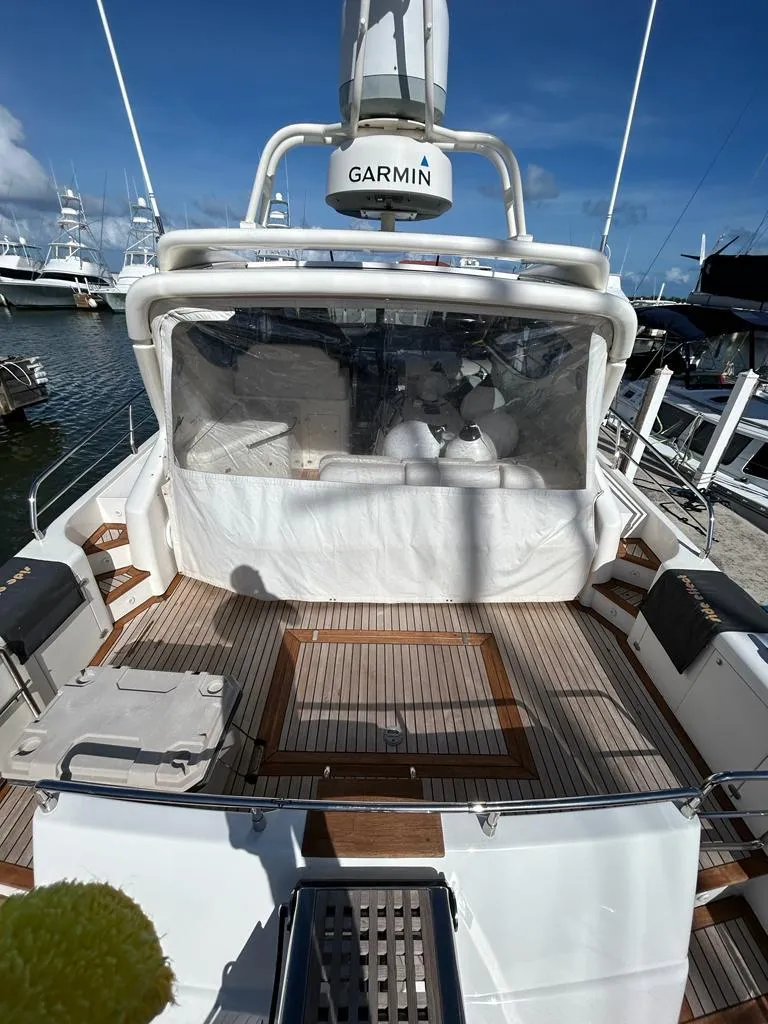 Slide: The Image of 2007 Uniesse 54 Sport yacht with Garmin navigation, docked at a marina. - 5