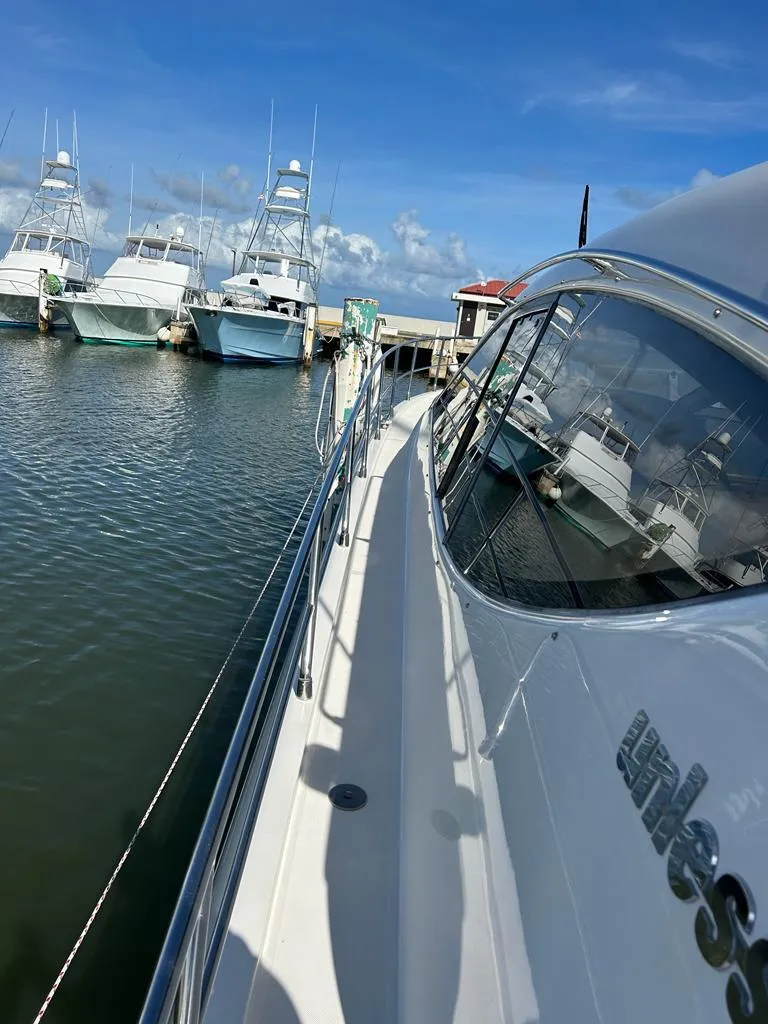 Slide: The Image of 2007 Uniesse 54 Sport yacht docked at a marina on a sunny day. - 8