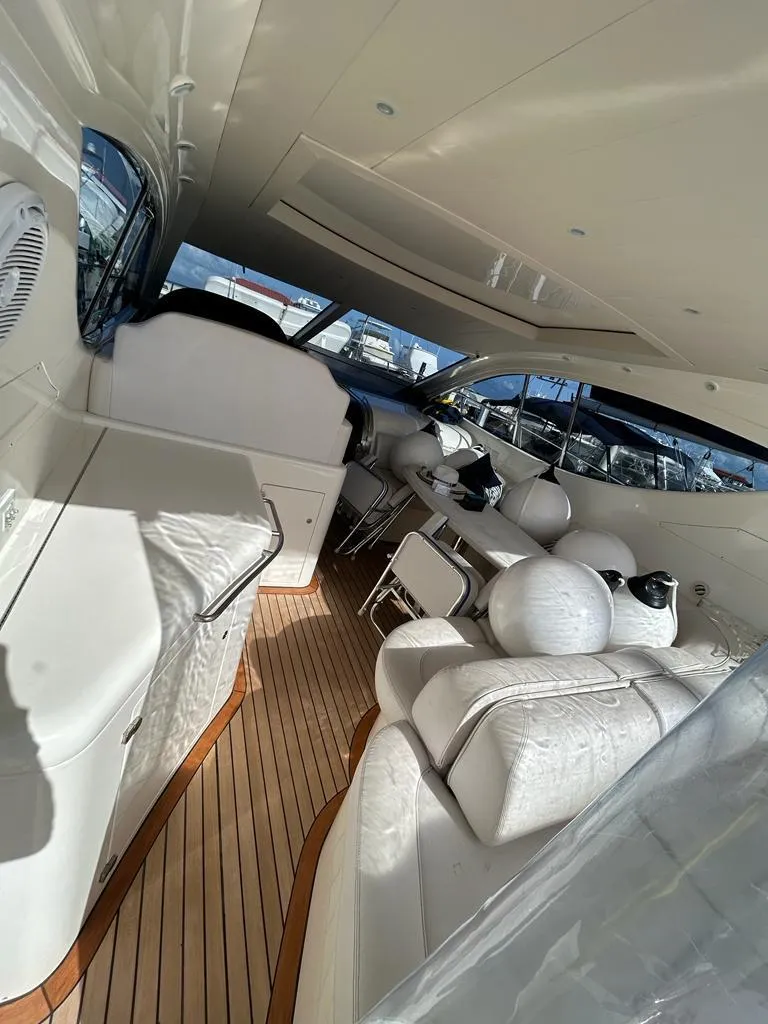 Slide: The Image of 2007 Uniesse 54 Sport yacht interior with white leather seating and wooden flooring. - 9