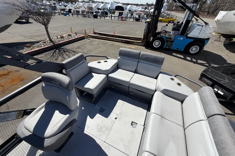 Slide: The Image of 2023 Sea-Doo Switch Cruise 21 pontoon boat interior with spacious seating and cup holders. - 10