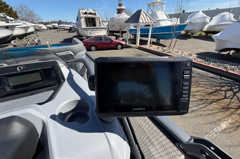 Slide: The Image of 2023 Sea-Doo Switch Cruise 21 with Garmin display in a marina setting. - 13
