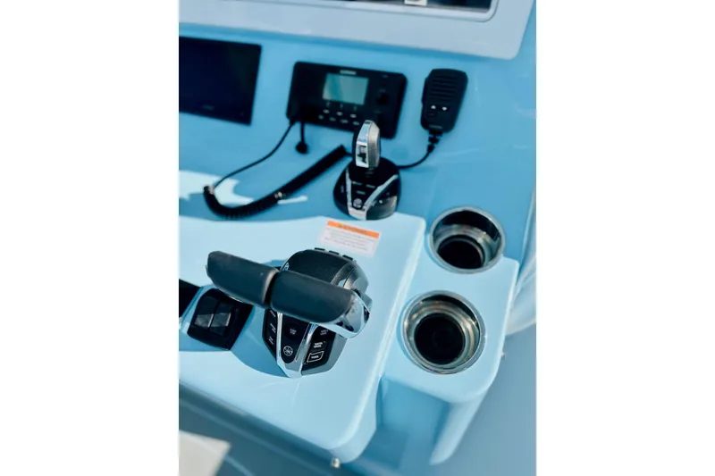 Slide: The Image of Control panel of 2025 Contender 39 ST boat with throttle and communication devices. - 14