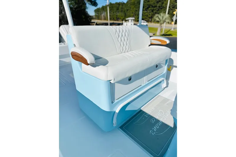 Slide: The Image of 2025 Contender 39 ST boat seat with white upholstery and wooden armrests. - 15