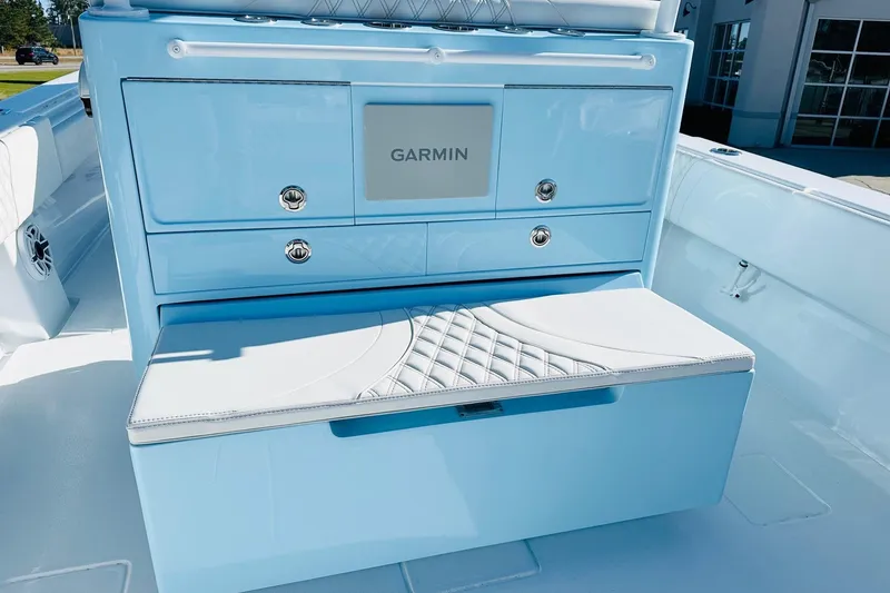 Slide: The Image of 2025 Contender 39 ST boat interior with Garmin equipment and cushioned seating. - 17