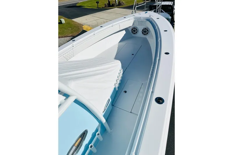 Slide: The Image of 2025 Contender 39 ST boat interior with sleek white deck and storage compartments. - 18