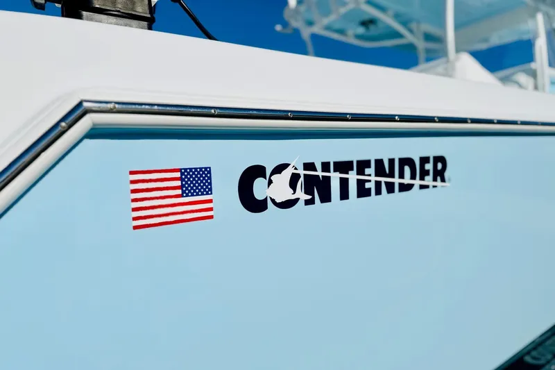 Slide: The Image of 2025 Contender 39 ST boat with American flag logo on light blue hull. - 26