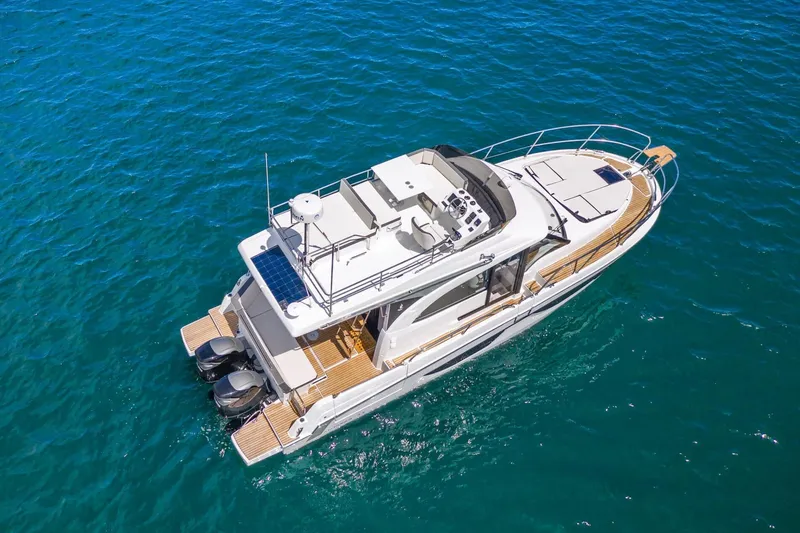 Slide: The Image of 2026 Beneteau Antares 11 yacht cruising on clear blue water. - 2
