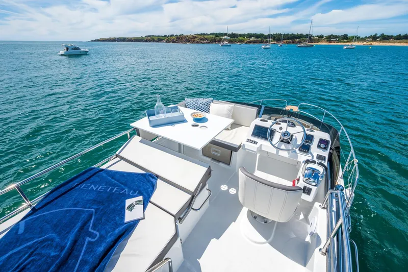 Slide: The Image of 2026 Beneteau Antares 11 yacht interior with helm, seating, and ocean view. - 20