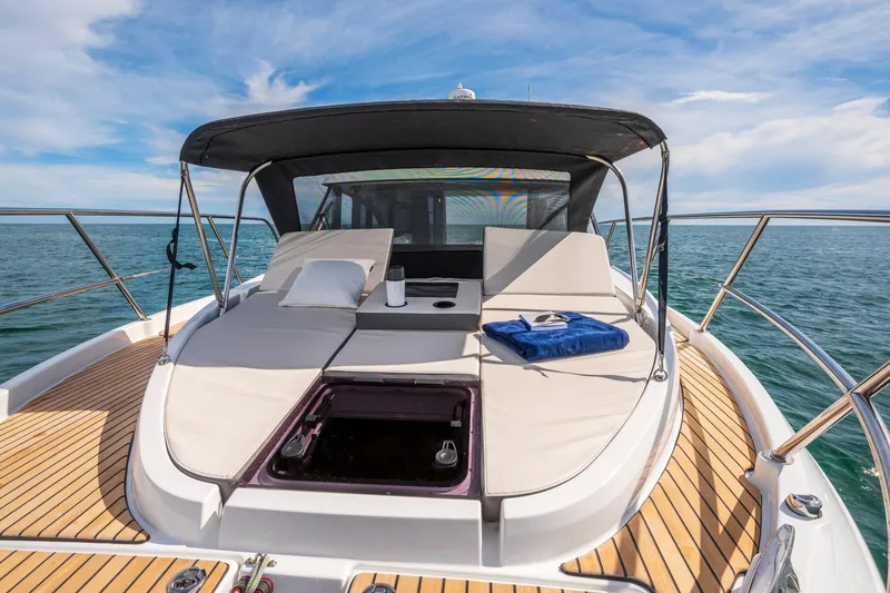 Slide: The Image of 2026 Beneteau Antares 11 yacht with sunbathing deck on open sea. - 25