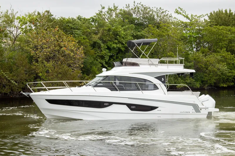 Slide: The Image of 2026 Beneteau Antares 11 yacht cruising on a calm river, surrounded by lush greenery. - 48