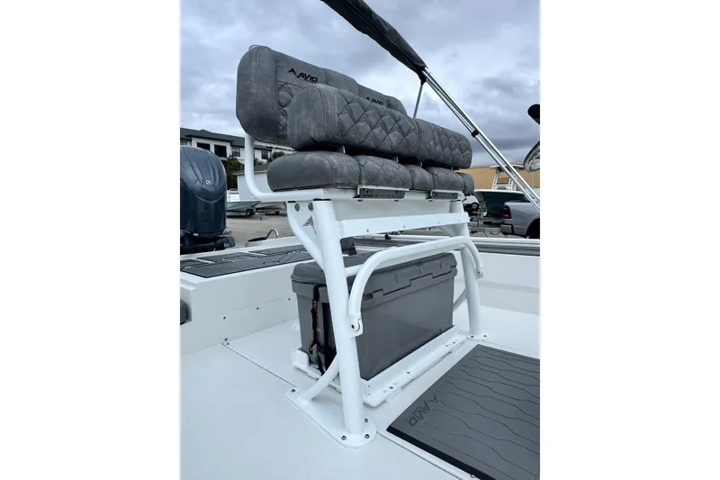 Slide: The Image of 2026 Avid 23 Fusion boat seating with storage, featuring gray cushioned seats and sturdy white frame. - 12