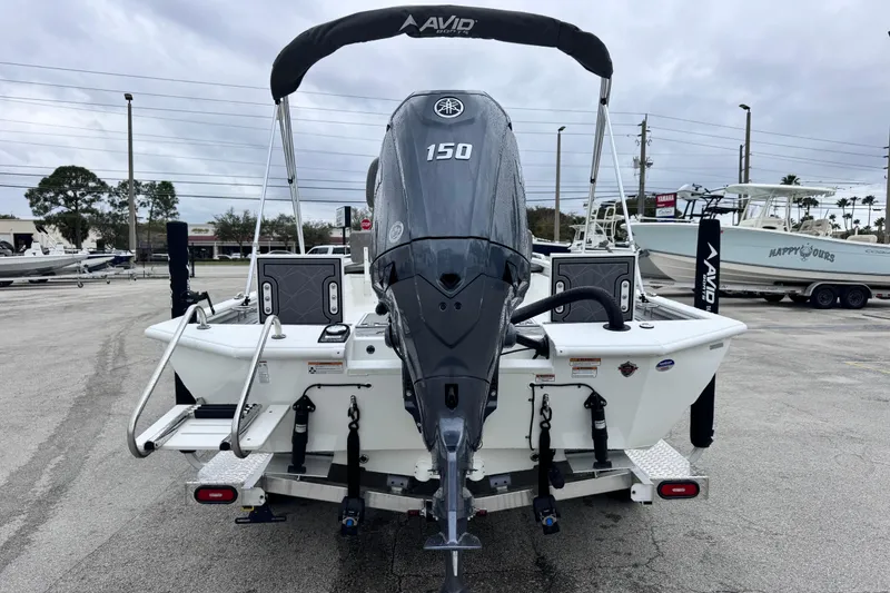 Slide: The Image of Avid 23 Fusion 2026 boat with Yamaha 150 engine, parked outdoors. - 4