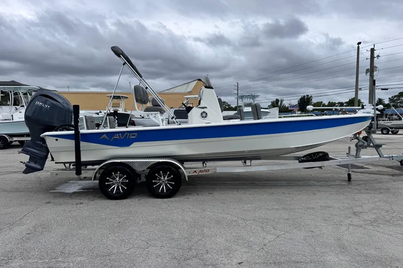 Slide: The Image of 2026 Avid 23 Fusion boat on trailer, featuring Yamaha outboard motor. - 6