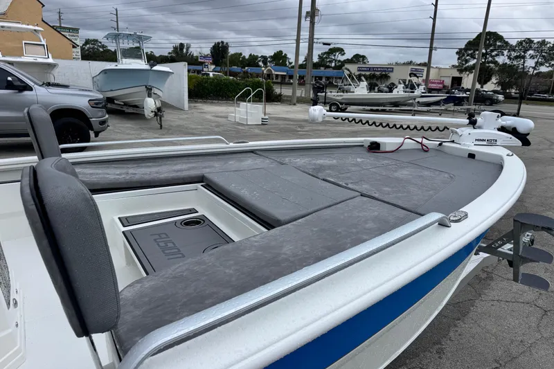 Slide: The Image of 2026 Avid 23 Fusion boat with Minn Kota trolling motor in parking lot. - 8