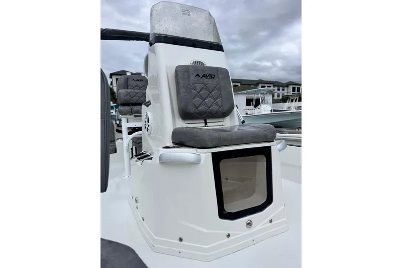 Slide: The Image of Avid 23 Fusion 2026 boat console with cushioned seating and storage compartment. - 9