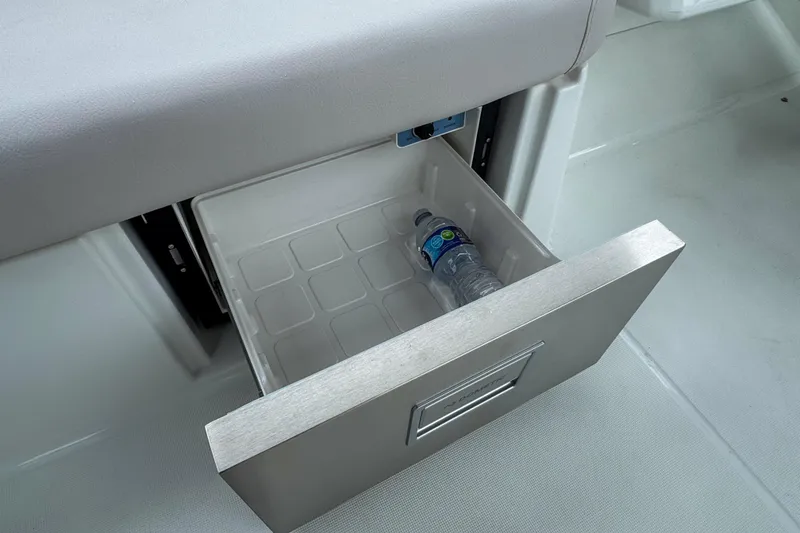 Slide: The Image of Open drawer with water bottle on Beneteau Antares 11, 2026 model. - 36