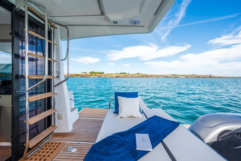 Slide: The Image of 2026 Beneteau Antares 11 yacht interior with ocean view, featuring a cozy seating area. - 8