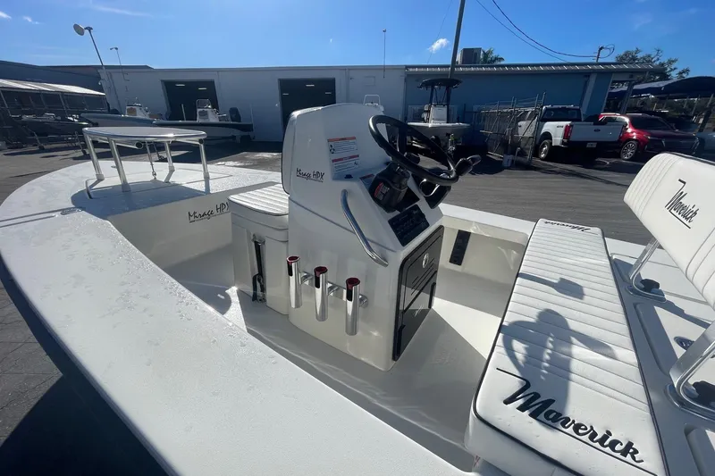 Slide: The Image of 2026 Maverick HPX-17 V boat interior with steering console and seating in a marina setting. - 7