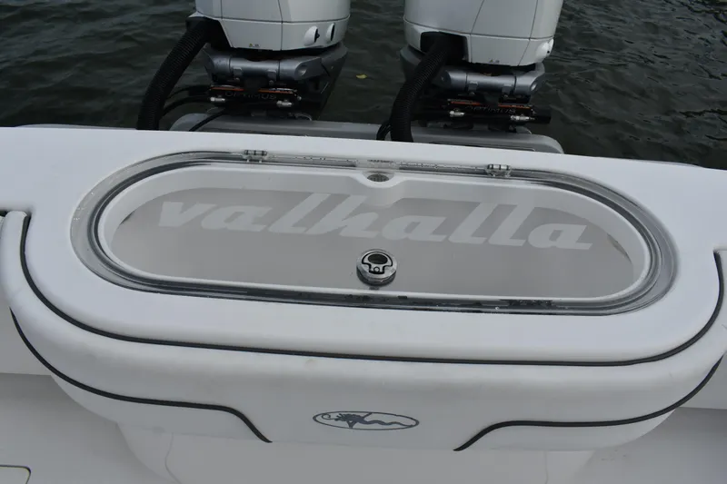 Slide: The Image of Valhalla V-33 2021 boat with dual engines and branded livewell on water. - 11