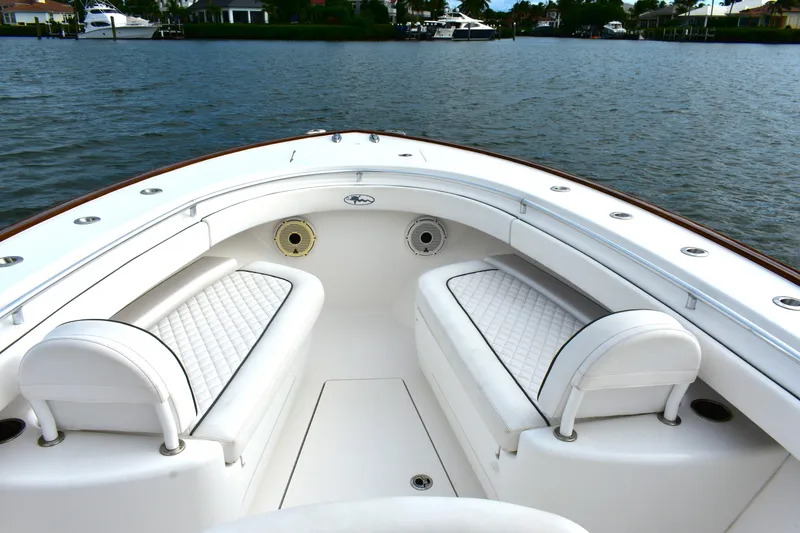 Slide: The Image of 2021 Valhalla V-33 boat interior with white seating, on calm water. - 14