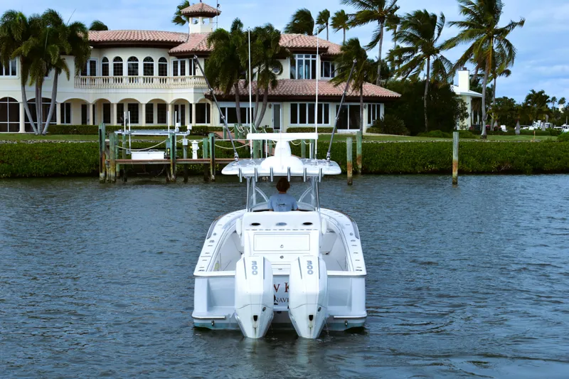 Slide: The Image of Valhalla V-33 boat cruising near luxury waterfront mansion, 2021 model. - 16