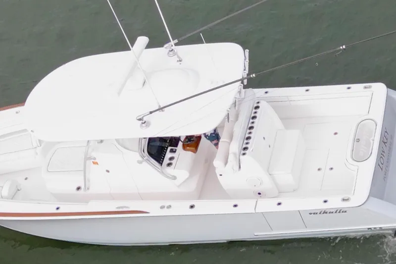 Slide: The Image of Aerial view of 2021 Valhalla V-33 boat on water, featuring sleek white design. - 19