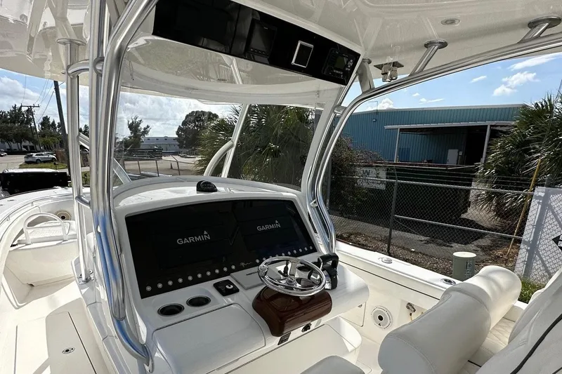 Slide: The Image of Valhalla V-33 2021 boat cockpit with Garmin navigation system and steering wheel. - 5