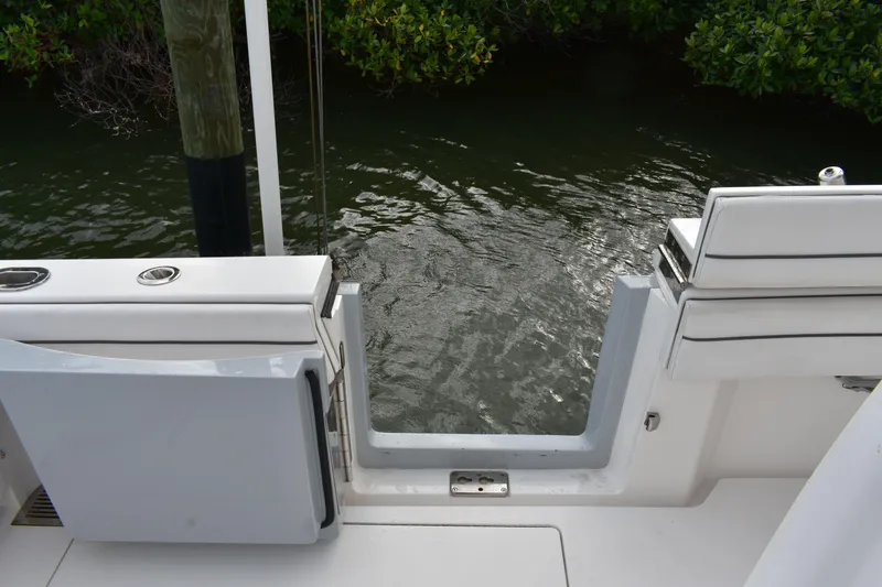 Slide: The Image of Valhalla V-33 boat stern view, open transom door, water and greenery in background. - 9