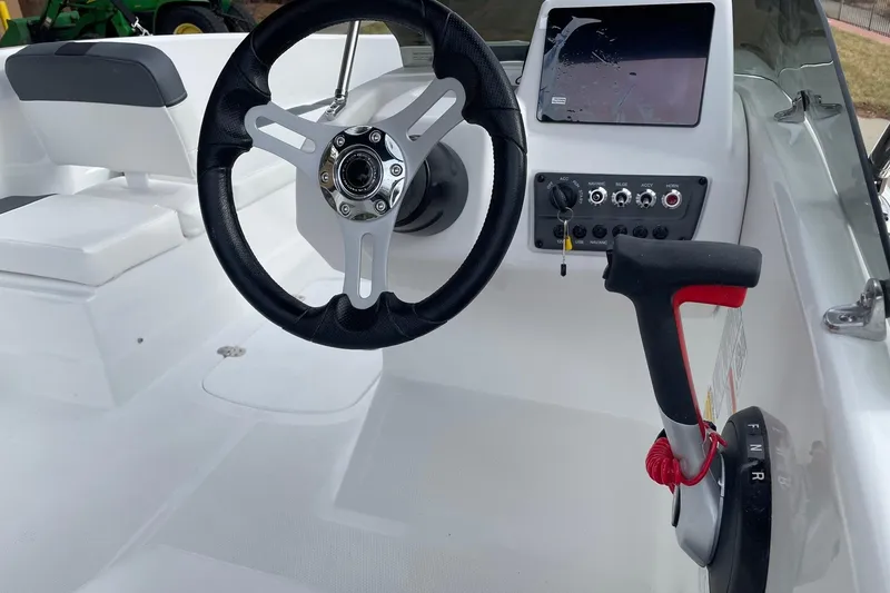 Slide: The Image of 2026 Tahoe T16 boat cockpit with steering wheel, control panel, and throttle lever. - 3