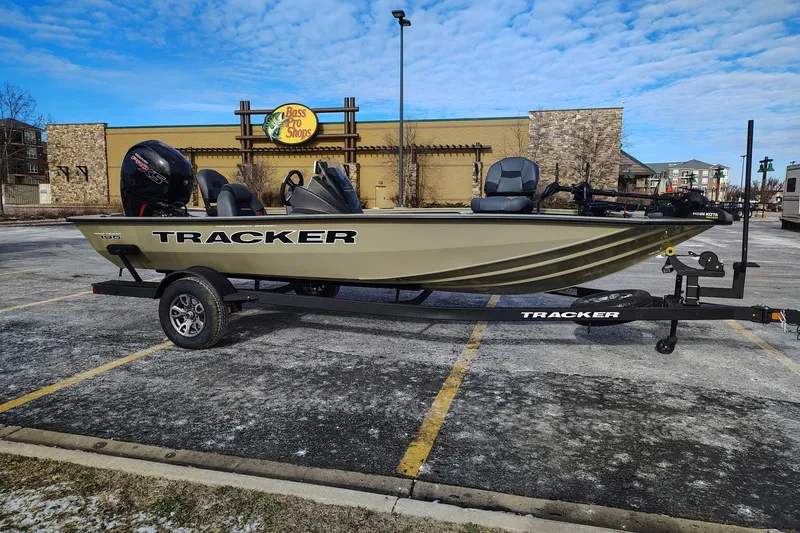The Image of 2026 Tracker Pro Team 195 boat on trailer in parking lot near Bass Pro Shops. - 0