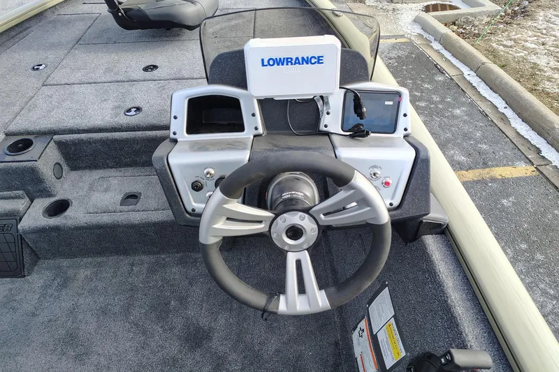 Slide: The Image of 2026 Tracker Pro Team 195 boat dashboard with steering wheel and Lowrance electronics. - 5
