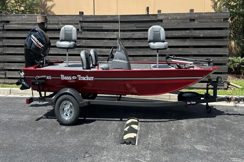 Slide: The Image of 2026 Tracker Bass Tracker Classic XL boat, red, parked on trailer, outdoor setting. - 3