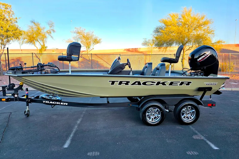 The Image of 2026 Tracker Pro Team 195 boat on trailer, parked outdoors with clear sky background. - 0