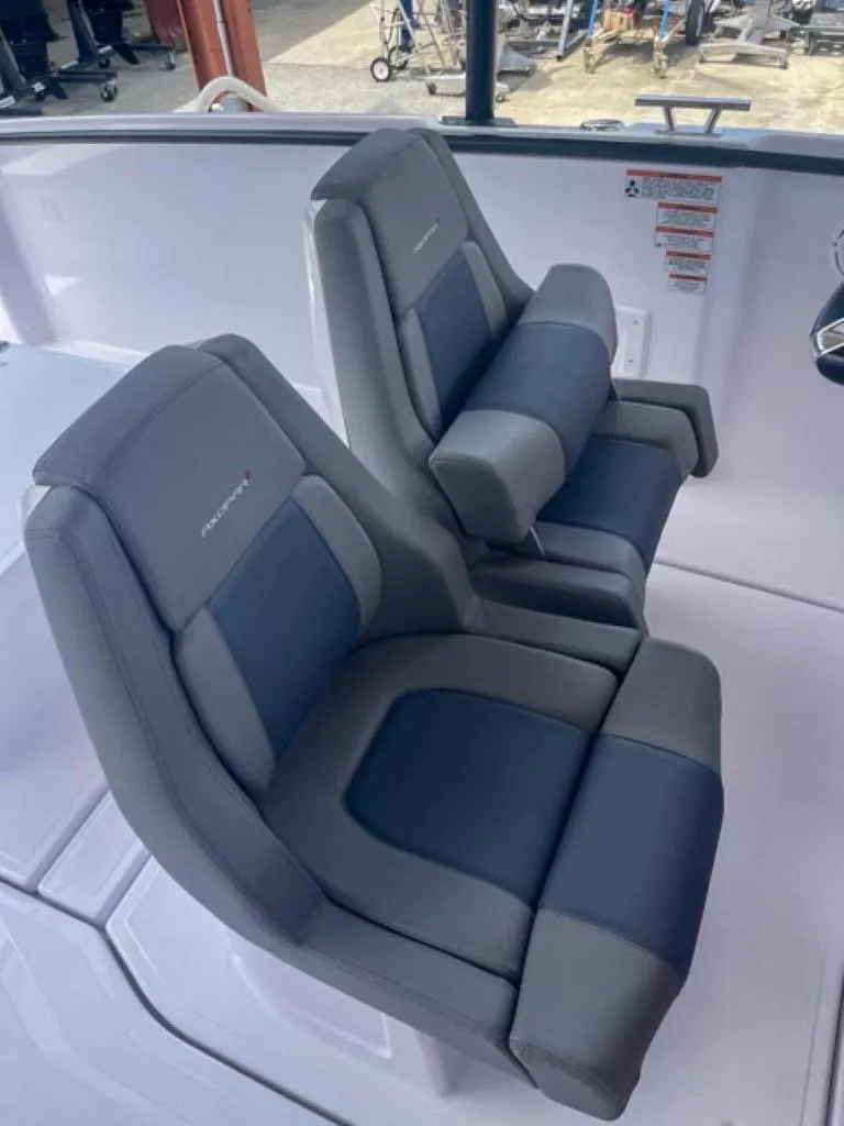 Slide: The Image of 2024 Axopar 25 Cross Top boat seats, featuring sleek gray and blue design. - 10