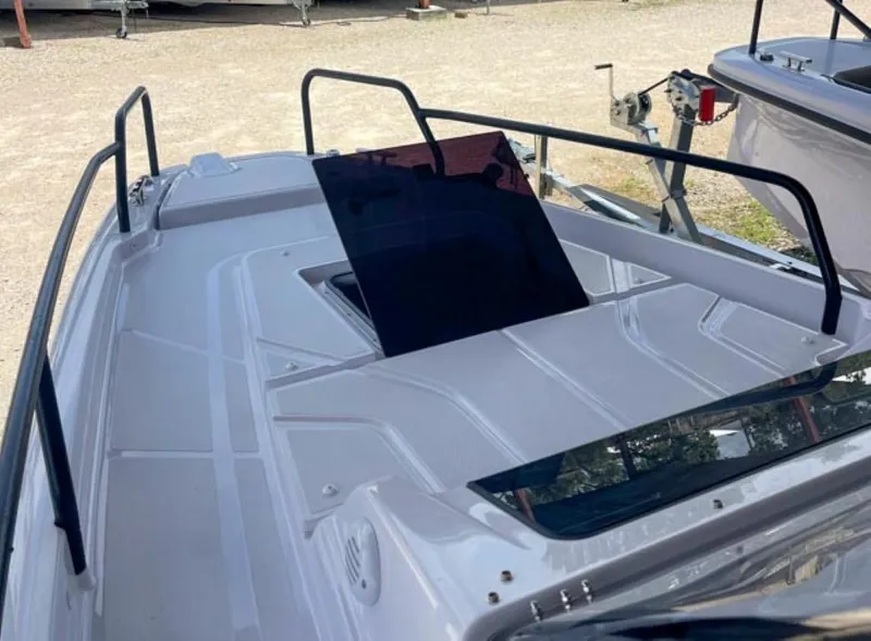 Slide: The Image of 2024 Axopar 25 Cross Top boat deck with sleek design and black railings. - 6