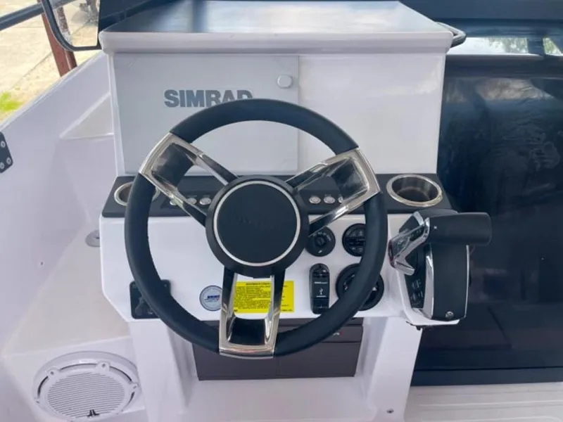 Slide: The Image of Steering wheel and controls of 2024 Axopar 25 Cross Top boat. - 7