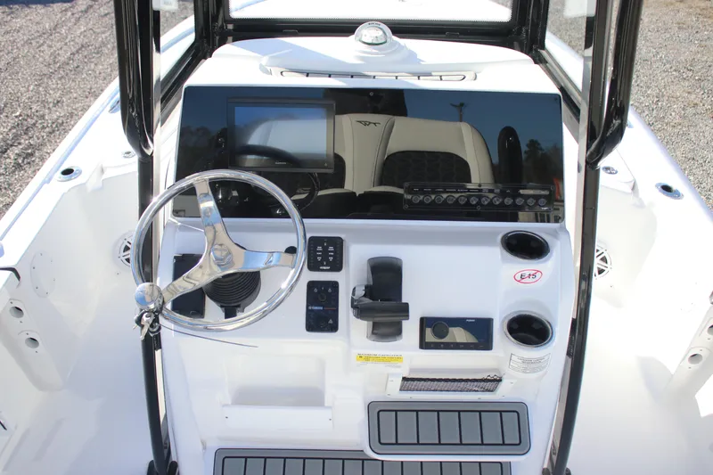Slide: The Image of 2026 Tidewater 2210 Carolina Bay boat console with steering wheel and controls. - 14