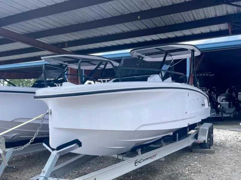 The Image of 2024 Axopar 25 Cross Top boat on trailer in covered storage. - 0