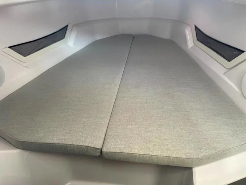 Slide: The Image of 2024 Axopar 25 Cross Top interior cabin with cushioned seating. - 13