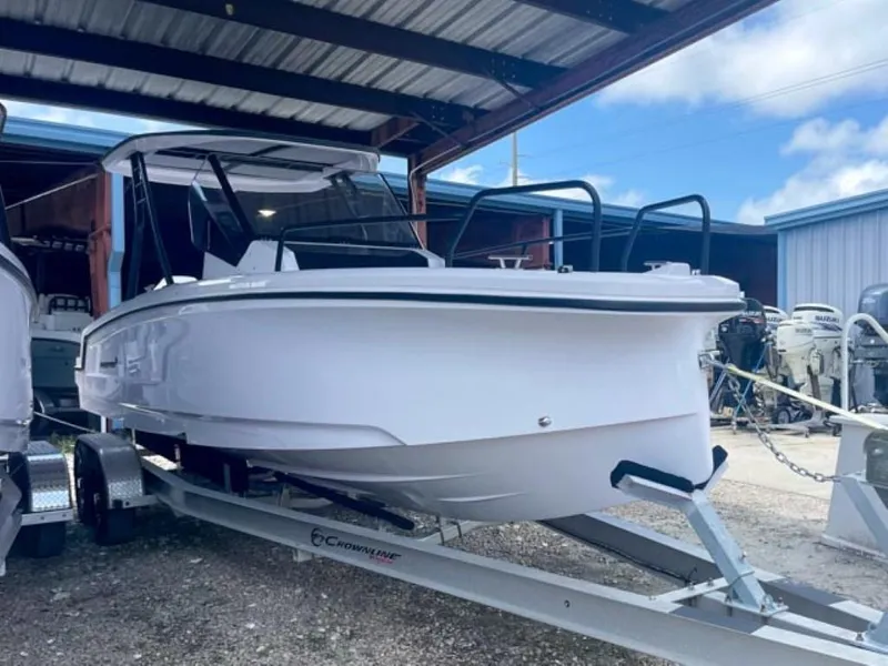 Slide: The Image of 2024 Axopar 25 Cross Top boat on trailer in storage facility. - 2